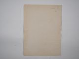 an old piece of paper sitting on top of a white wall