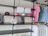 a rack with clothes and other items on it in a room