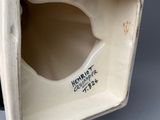 an image of a close up of a vase with a label on it