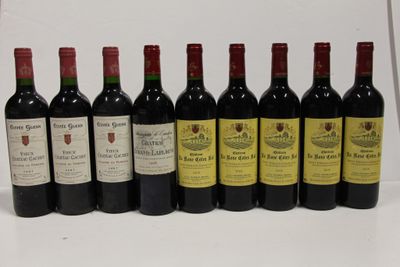 six bottles of wine are lined up in a row on a white surface