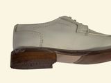 a close up of a shoe with a wooden sole
