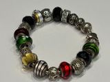 a close up of a beaded bracelet on a white surface