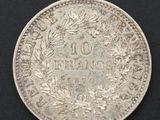 a close up of a silver coin on a black surface