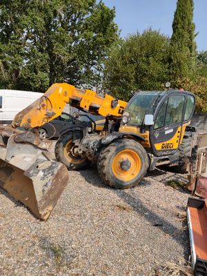 a tractor and a bulldozer in a gravel lot