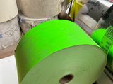a roll of green tape sitting on a pallet next to other rolls of tape