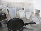pots and pans are sitting on a kitchen counter with measuring cups