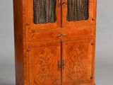 an antique wooden cabinet with glass doors and a marble top