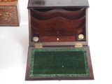 a small wooden box with a green mat on the floor