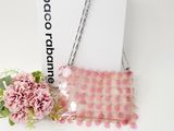 the pink purse is next to a pink flower and a white box