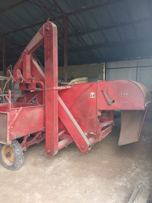 an image of a large red machine in a barn