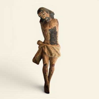 an old statue of a man with a cross on a white background