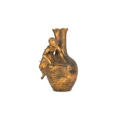 un vase en or surmonté d'un oiseau