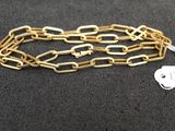 a close up of a gold chain with a tag on it
