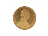 a close up of a gold coin on a white surface
