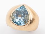 an image of a gold ring with a blue topazt stone