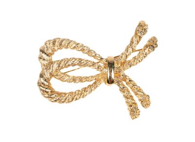 broche en forme de nœud en métal plaqué or avec des pierres en cristal