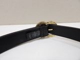 a close up of a black belt with a gold buckle