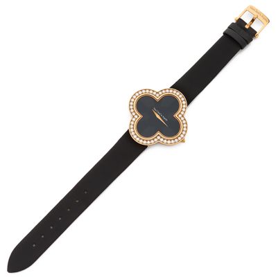 a close up of a watch on a white surface with a black strap