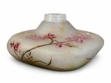 a white vase with pink flowers on it on a white surface