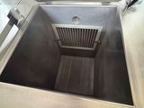 a stainless steel box with a vent in it
