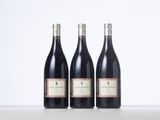 three bottles of wine sitting on top of a table next to each other