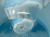 a close up of a blue bowl with a label on it