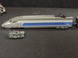 a toy train that is sitting next to a toy car