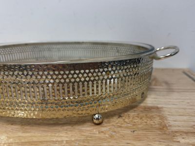 a metal strainer sitting on a wooden table