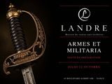 a sword with a gold handle on a black background