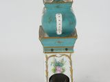 a small blue and white machine with a clock on top of it