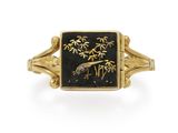 an image of a gold and black enamel ring with a bird on it