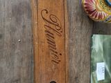 a wooden box that has a vase and other items on it