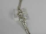 a close up of a silver bracelet on a white surface