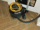 a vacuum that is sitting on the floor next to a mirror
