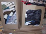 two boxes of clothing sitting on top of each other in a warehouse