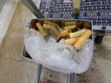 a metal container filled with cigarettes and ice on the ground