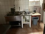 a small kitchen with a sink and a stove in it