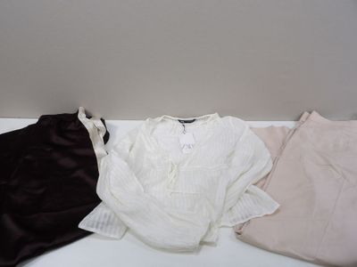 three pieces of clothing sitting on a white table