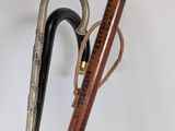 a wooden stick and a metal instrument on a white surface