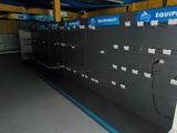a lot of empty shelves in a store with blue and white labels