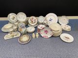 a lot of plates and bowls on the table