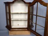 a small wooden display case with a mirror on top of it