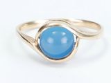a close up of a gold ring with a blue stone