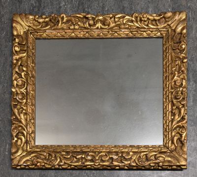un gros plan d'un miroir à cadre doré accroché au mur