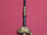 a sword on a table with a knife on it