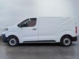 the white van is parked on the concrete floor in the room