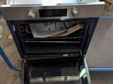 an open oven with the door open and a newspaper inside of it