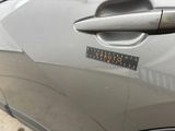 the door handle of a car with a sticker on it