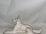an image of a statue of a dog laying down on a white background