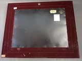 a picture of a mirror hanging on the wall